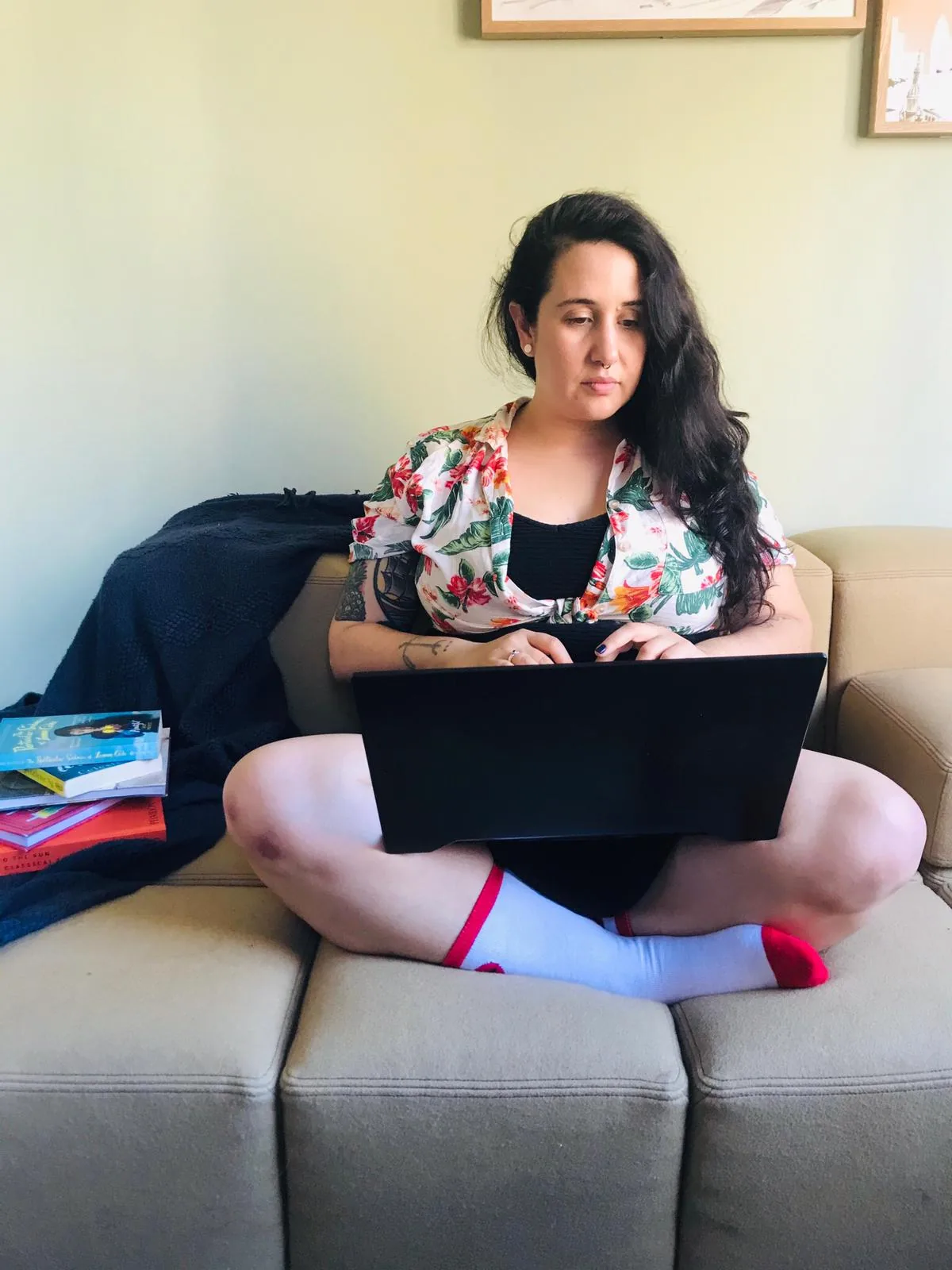 Jimena Serfaty working from a couch, casual candid portrait of the keynote speaker